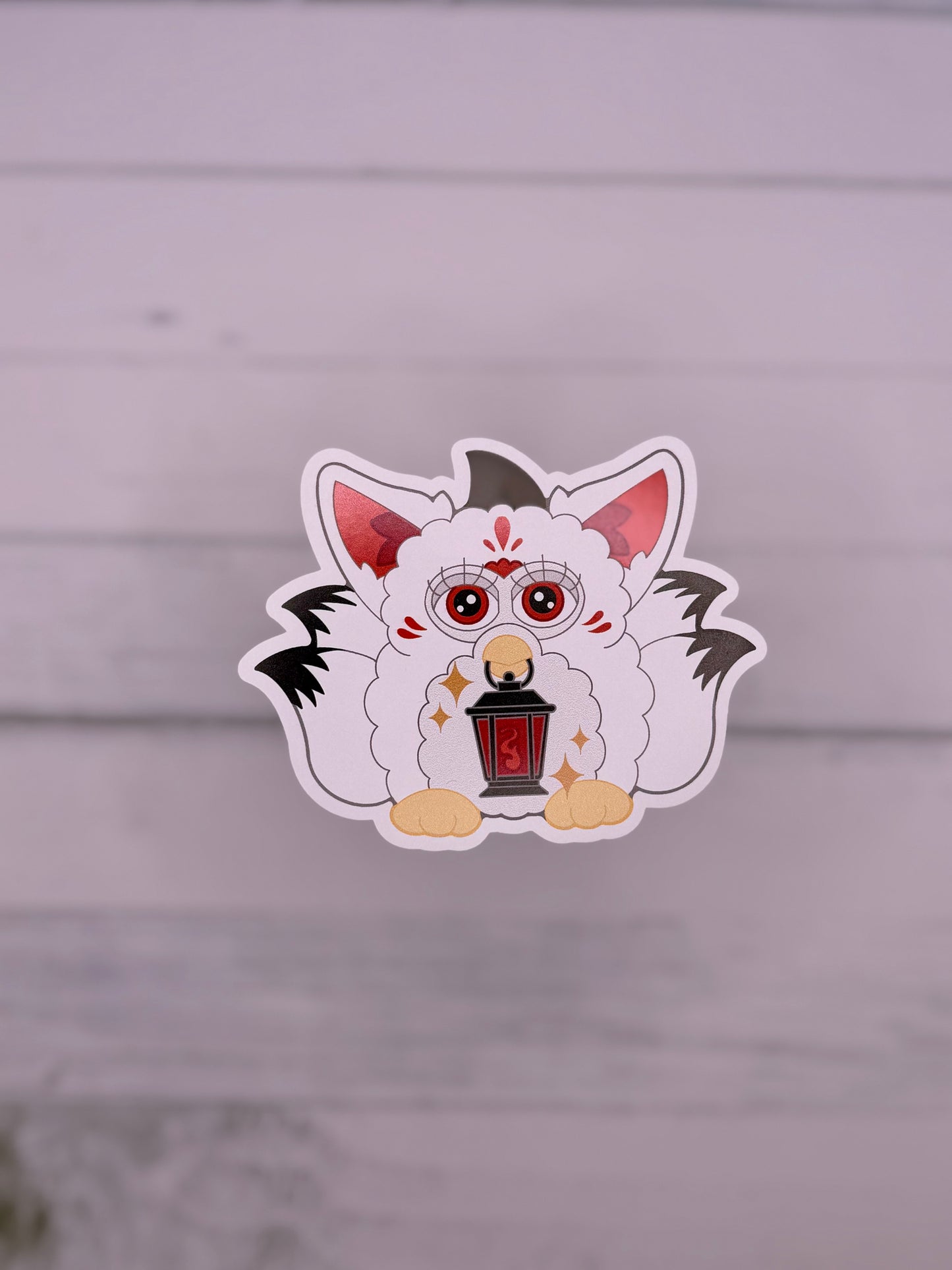 Black white and red retro electronic pet inspired fox spirit sticker holding a lantern with celestial details and fluffy tails