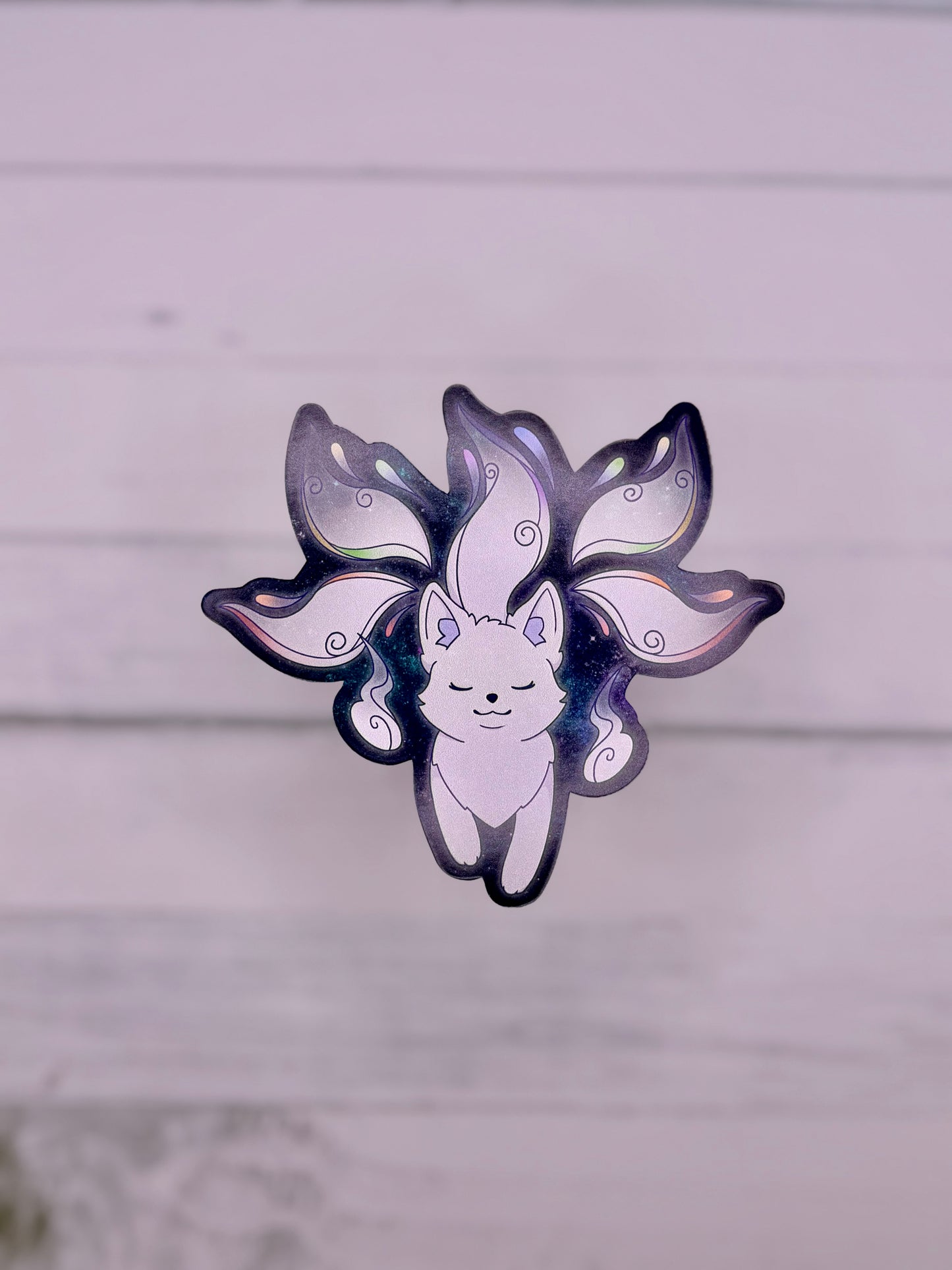Galaxy themed sticker featuring a white fox spirit with flowing tails on a dark blue starry background