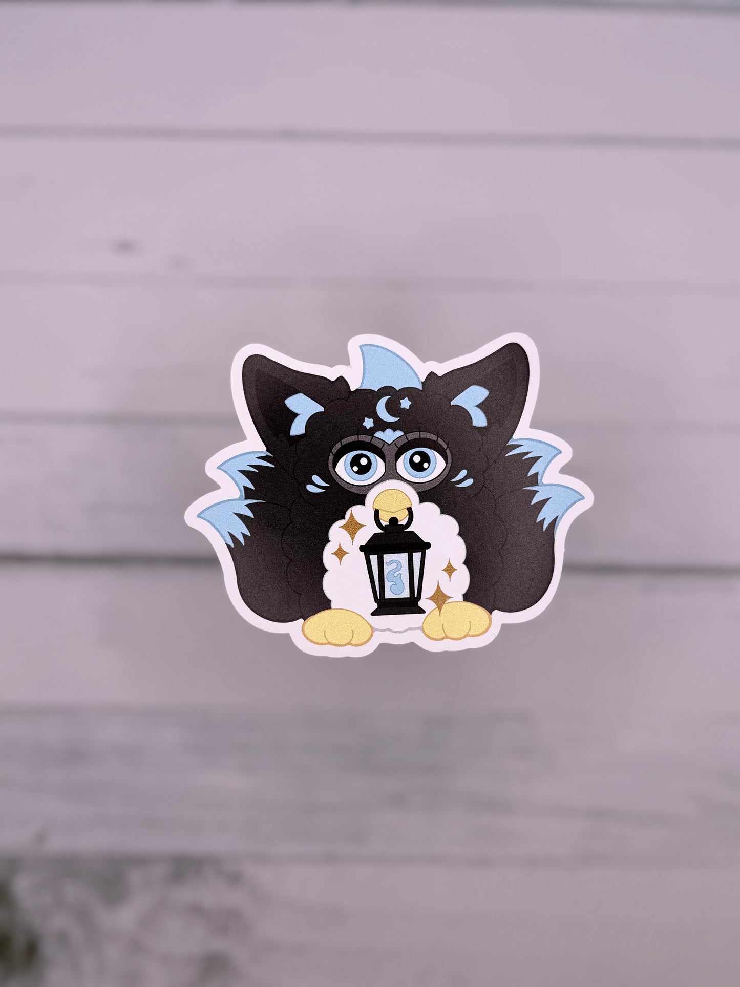 Black and blue retro electronic pet inspired fox spirit sticker holding a lantern with celestial details and fluffy tails