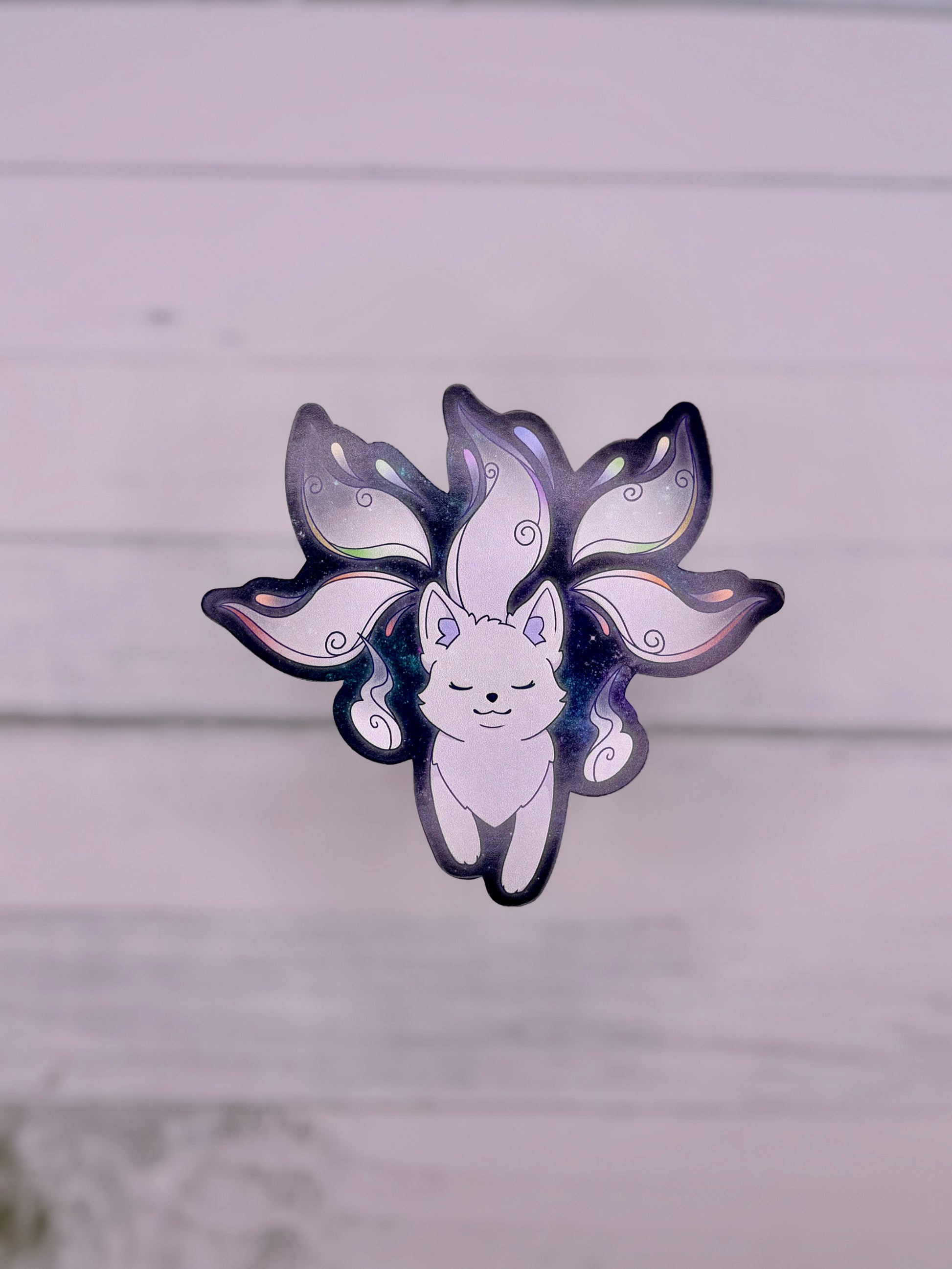 Galaxy themed sticker featuring a white fox spirit with flowing tails on a dark blue starry background