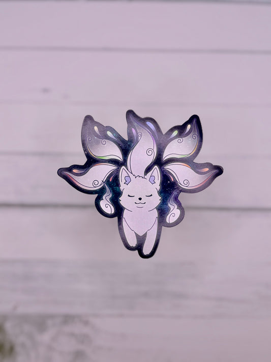 Galaxy themed sticker featuring a white fox spirit with flowing tails on a dark blue starry background
