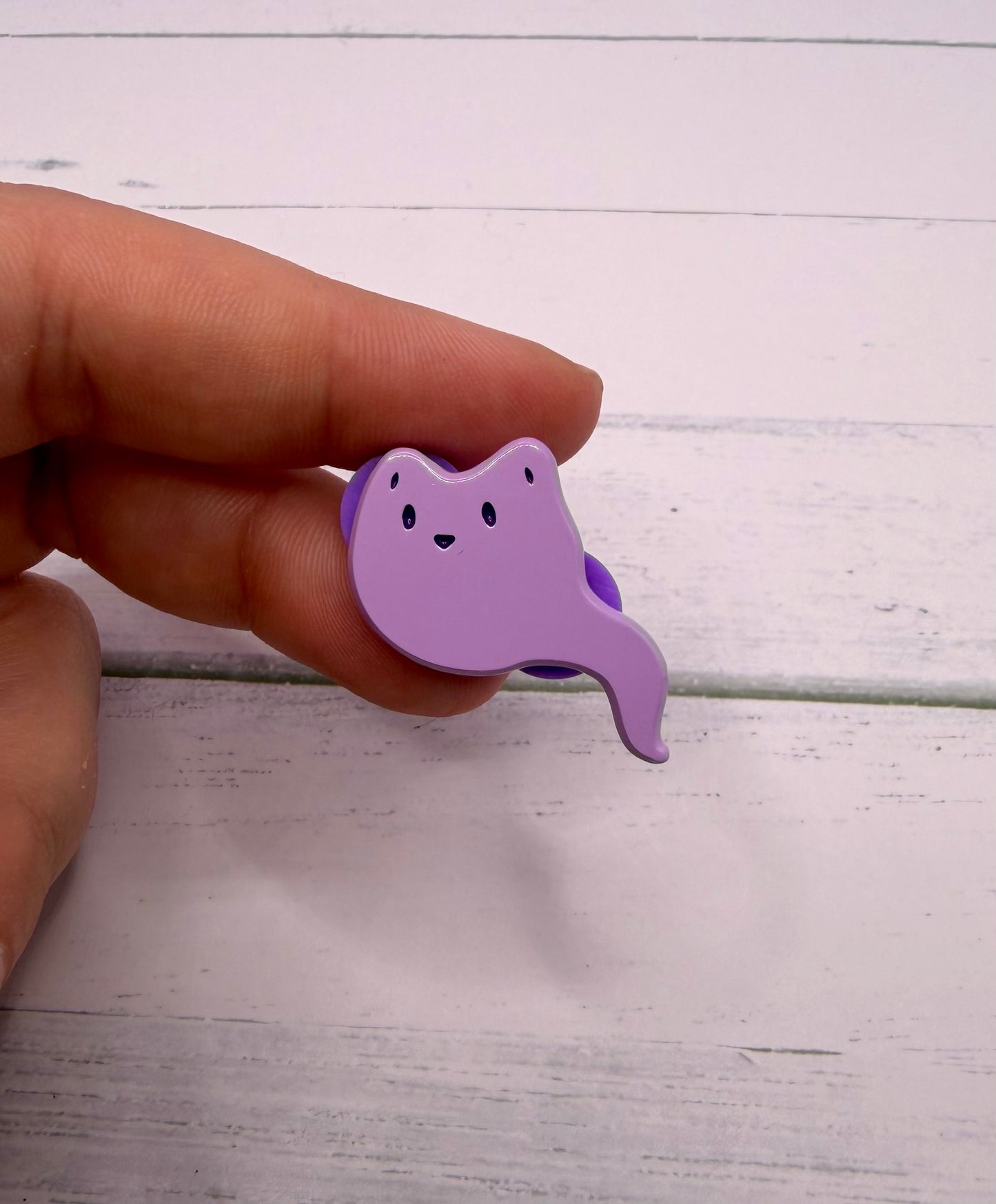 Purple ghost fox enamel pin with a curved ghost tail