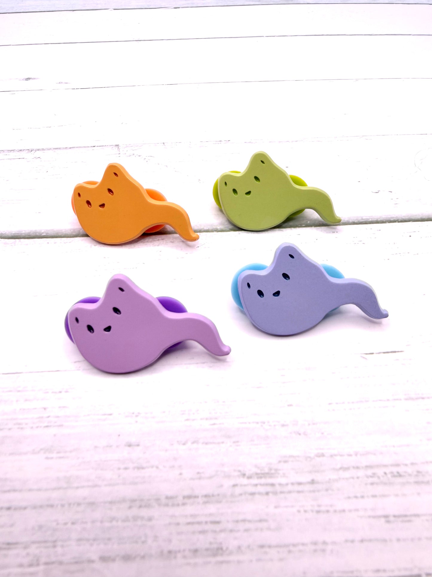 Set of four pastel ghost fox enamel pins in orange, green, lavender, and periwinkle with flowing tails